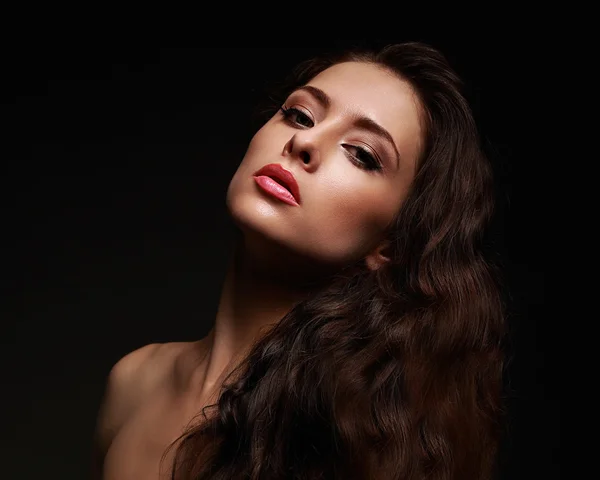 Beautiful makeup woman with long curly hair on black background