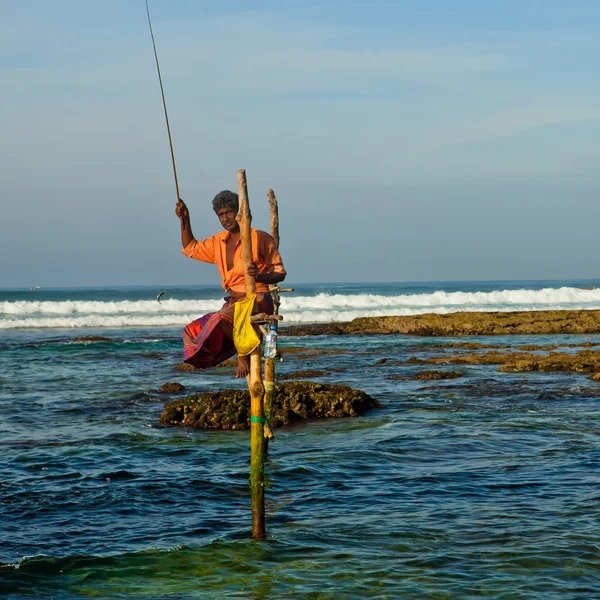 Sri Lankan traditional fisherman on stick in the Indian ocean