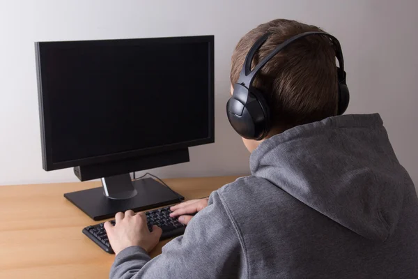 Young man using a computer and listening music
