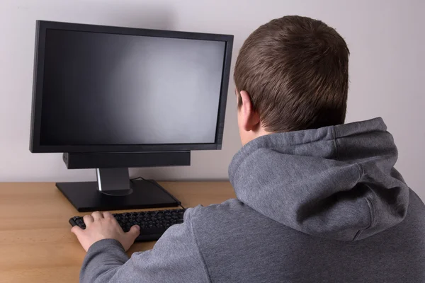 Young man using a personal computer