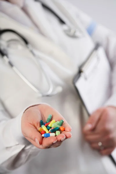 Doctor showing a handful of pills