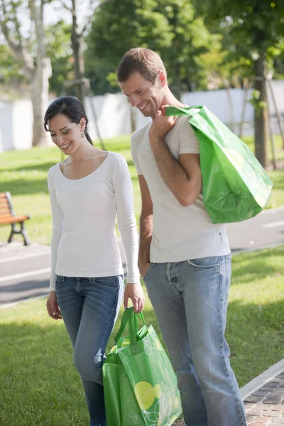 Young couple with reusable bags