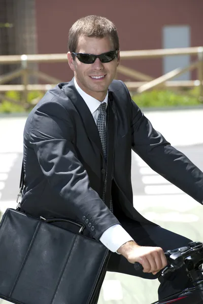 Environmentally conscious businessman riding a bike