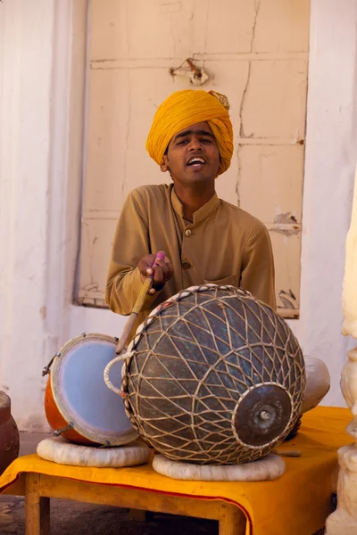 Folk indian singer playing drums