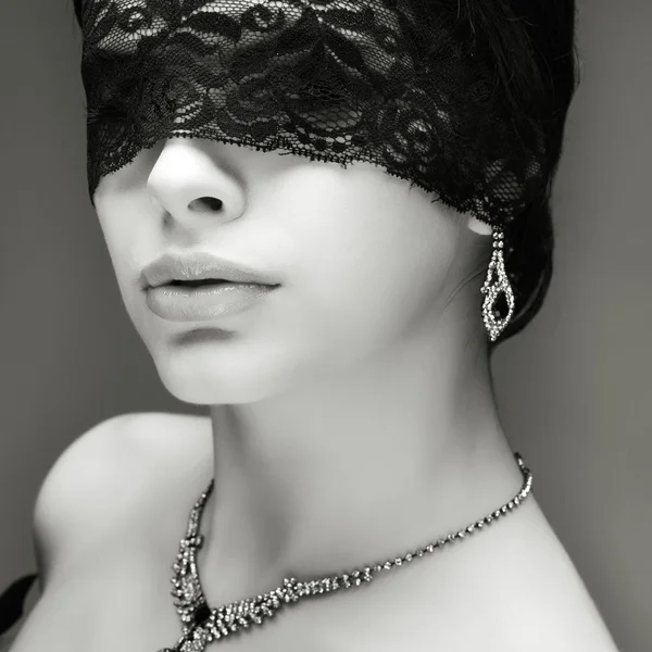 Portrait elegant sexual brunette woman is in a black lace mask