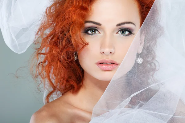 Portrait of beautiful redheaded bride. Wedding dress. Wedding decoration