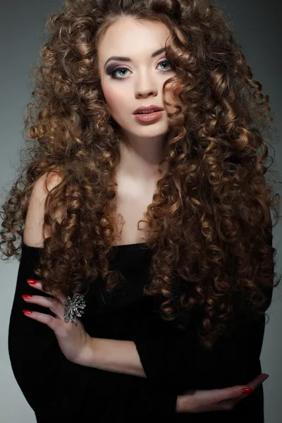 Young beautiful woman with long curly hairs