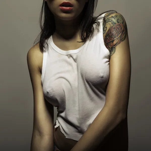 Tattoo girl in wet t-shirt