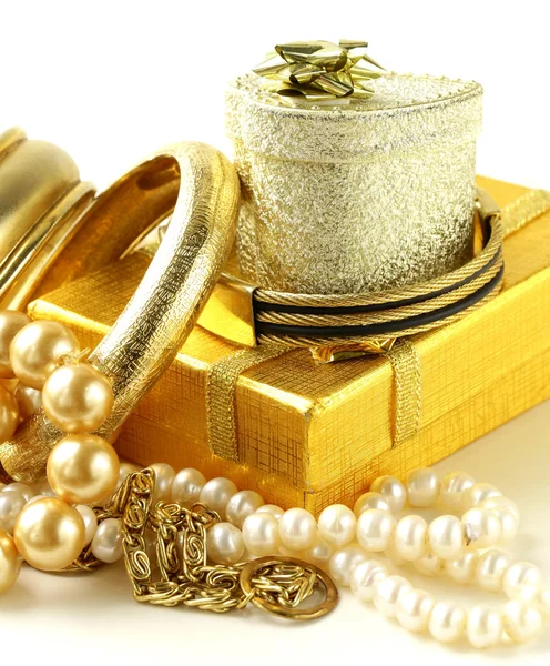 Gold and pearl jewelry, gift boxes on a white background
