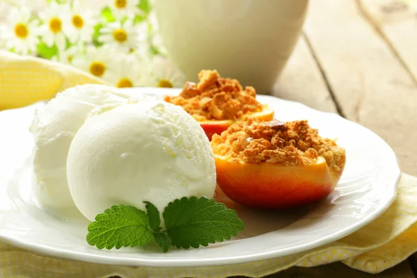 Baked peaches with a scoop of ice cream, summer dessert