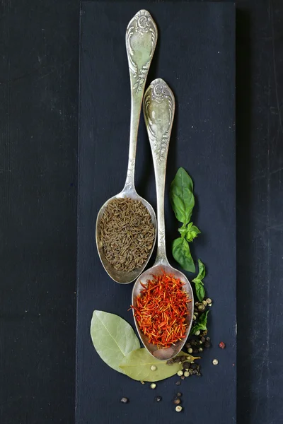 Spice saffron and cumin in a vintage spoons