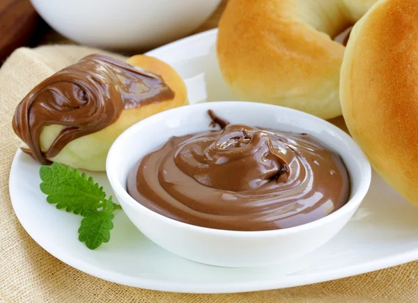 Chocolate nut paste (nutella) for breakfast with bread rolls
