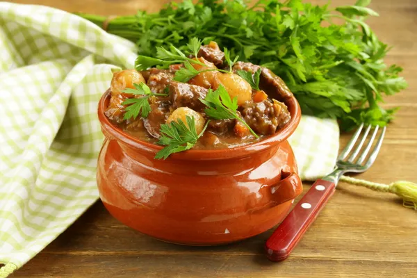 Beef stew with vegetables and herbs in a clay pot - comfort food