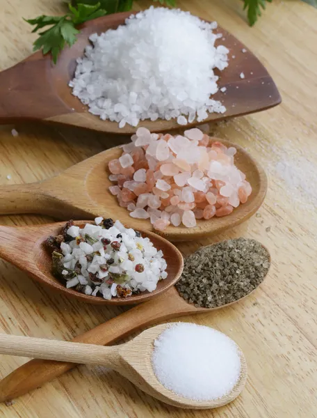Different types of salt (pink, sea, black, and with spices)