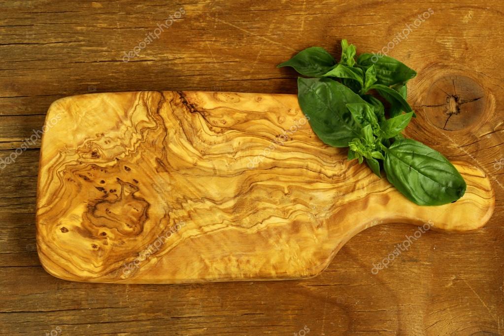 Kitchen cutting board on a wooden background — Stock Photo © Dream79