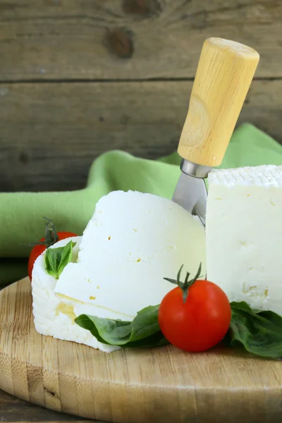 Salted milk cheese (feta cheese) on a wooden chopping board