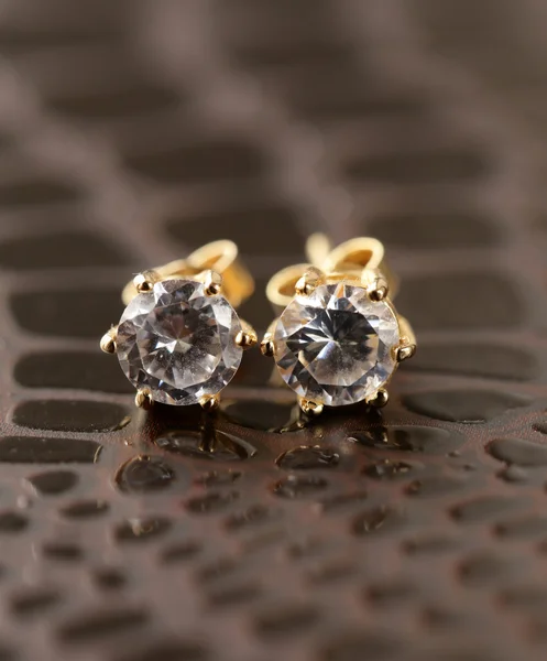 Gold earrings stud with diamonds macro shot