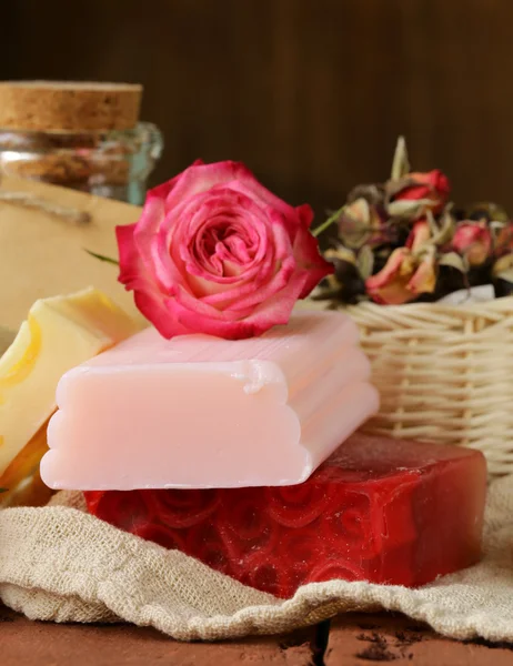 Handmade soap with the scent of roses on a wooden table