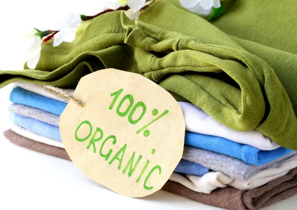 Stack of multicolored clothing with organic label