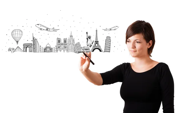 Young woman drawing famous cities and landmarks on whiteboard