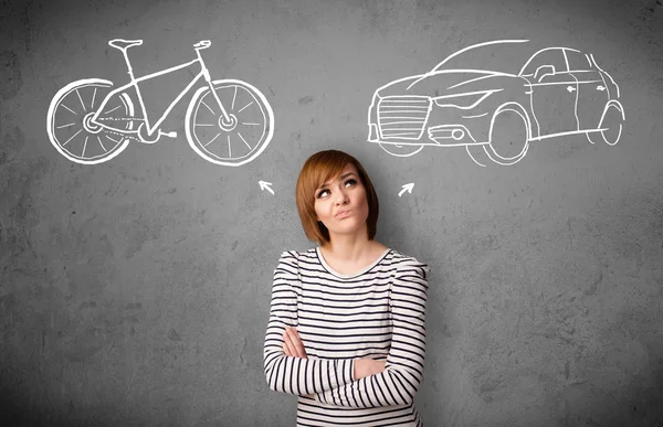 Woman making a choice between bicycle and car