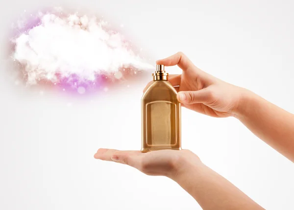 Woman hands spraying colorful cloud