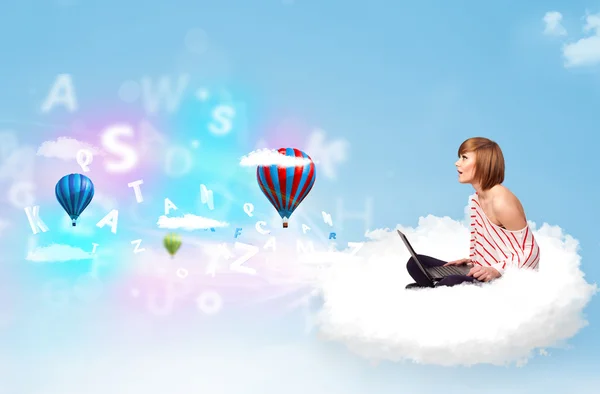 Young woman sitting in cloud with laptop