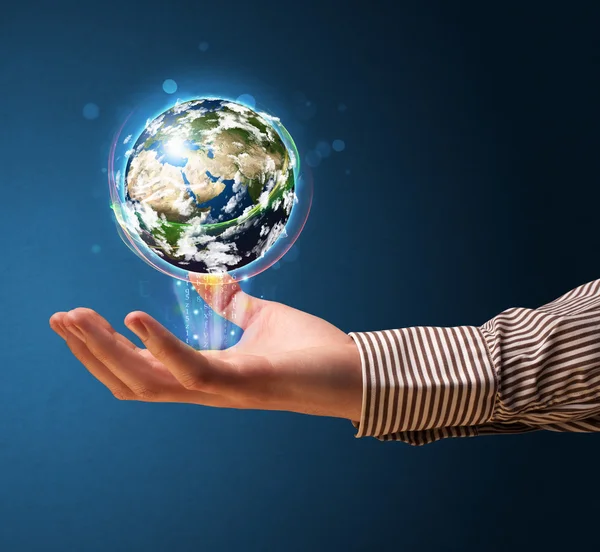 Businessman holding a glowing earth globe
