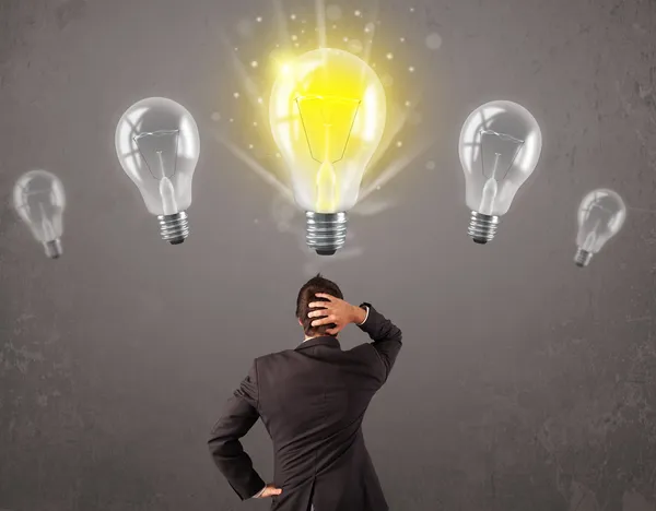 Business person having an idea light bulb concept