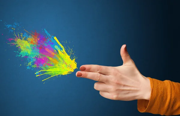 Colorful splashes are coming out of gun shaped hands