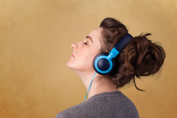 Young woman with headphones listening to music with copy space
