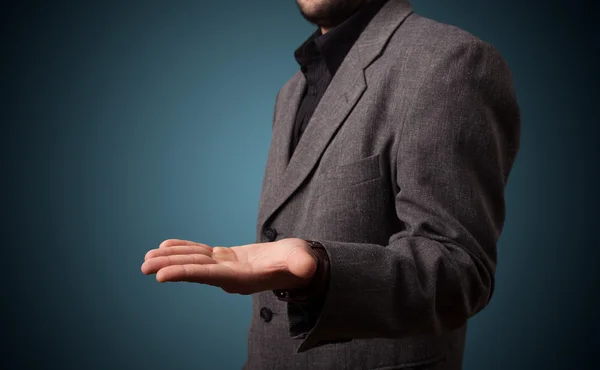 Handsome business man presenting with hand copy space