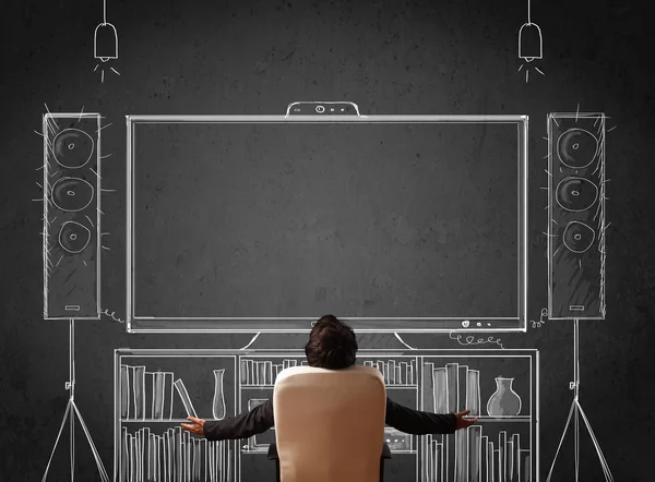 Businessman in front of a home cinema system