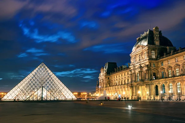 The Louvre museum at night in Paris