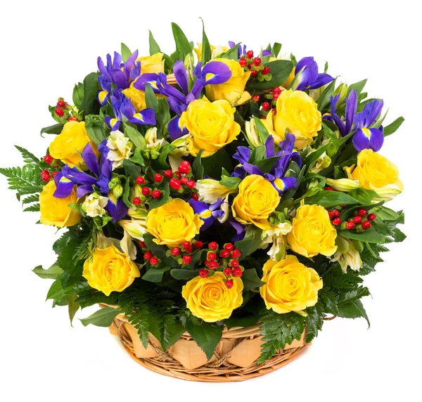 Natural yellow roses and blue irises in a basket