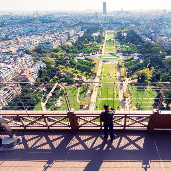 Tourist looking to the Champ de Mars on the observation deck of