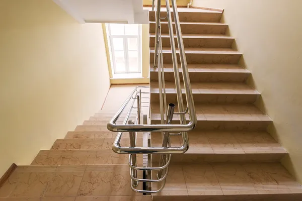 Staircase with metallic handrails