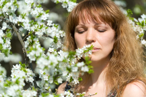 Young woman and cherry blossom