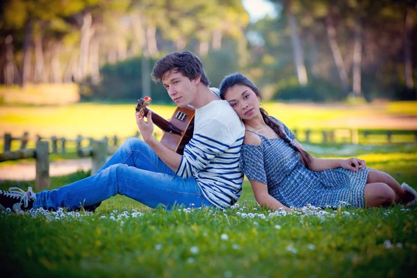 Romantic couple playing guitar — Stock Photo #20803289