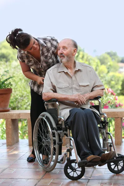 Elderly man out for walk in wheelchair