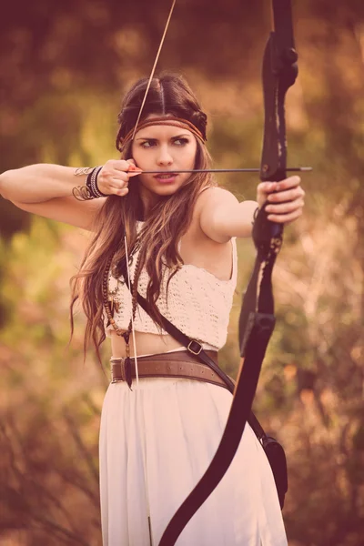 Woodland hunter woman with bow and arrow