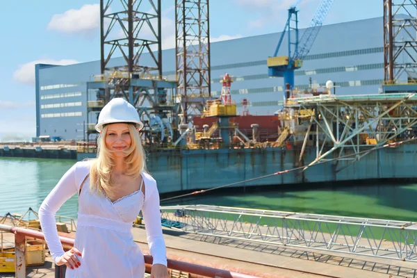 Woman engineer shipbuilder at the shipyard.