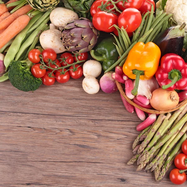 Healthy organic vegetables on a wood background