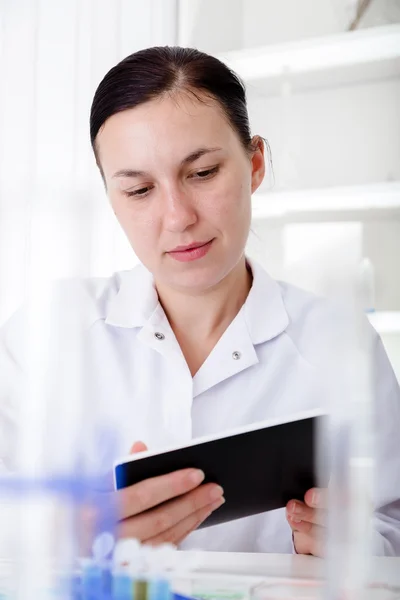 Female Scientist Using Tablet  In Laboratory