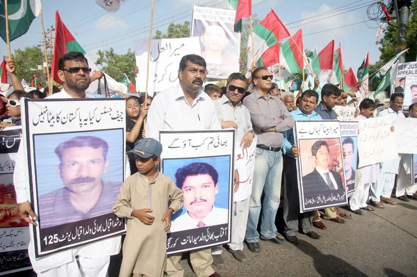Residents of Karachi are chant slogans for recovery of missing persons during a protest demonstration arranged by Muttehida Qaumi Movement (MQM)