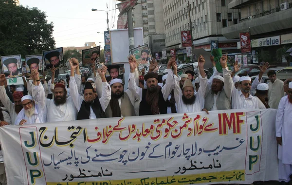Activists and supporters of Jamiat-e-Ulema-e-Pakistan are chanting slogans against increasing of power tariff during a protest demonstration