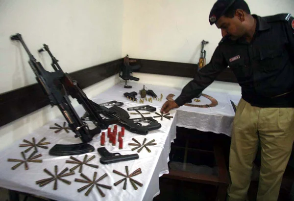 Police officials showing recovered weapon during a raid in connection of peace impose on arrival of Moharram-ul-Haram