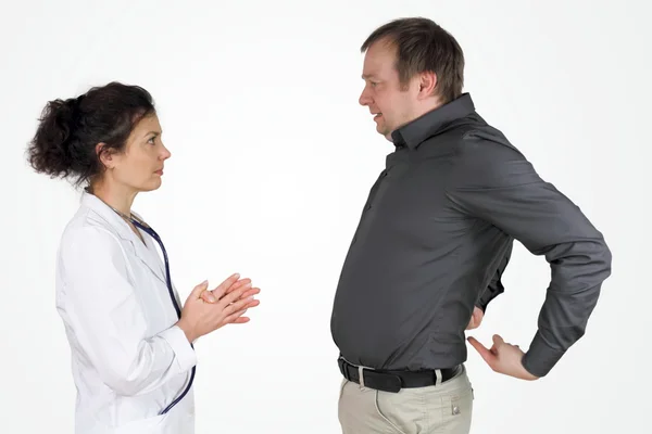 Back pain - the male patient describes and shows his problem with his back