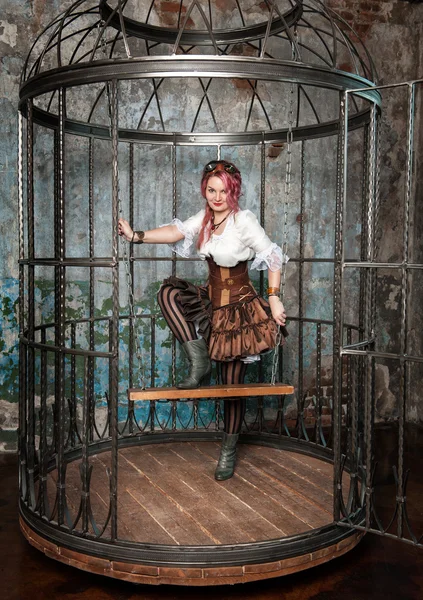 Beautiful steampunk woman in the cage