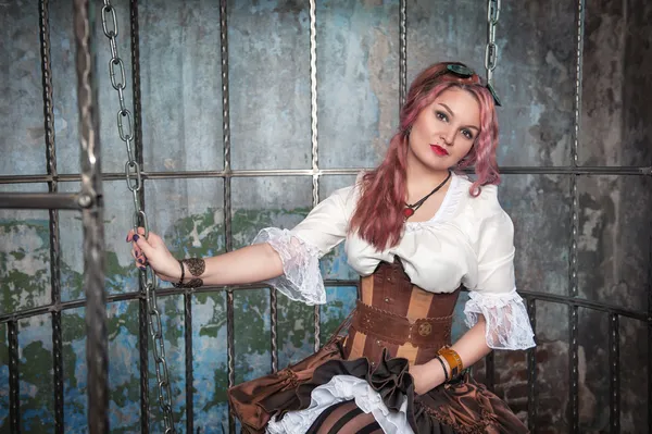 Beautiful steampunk woman in the cage